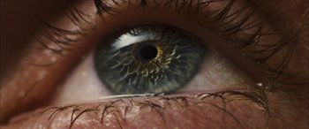 Movie still from “Looper” (2012), directed by Rian Johnson – View of a person's eye; Extreme Close Up shot, Overhead angle
