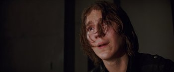 Movie still from “Looper” (2012), directed by Rian Johnson – A person with wet brown hair; Close Up shot, Low angle