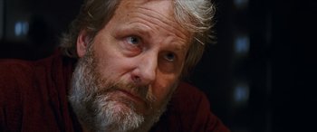 Movie still from “Looper” (2012), directed by Rian Johnson – An old man with a beard and a white mustache; Close Up shot, Low angle
