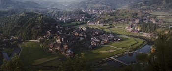 Movie still from “Looper” (2012), directed by Rian Johnson – An aerial view of a small town in the middle of the day; Extreme Wide shot, High angle