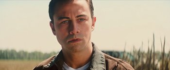 Movie still from “Looper” (2012), directed by Rian Johnson – A person wearing a jacket; Close Up shot, Low angle