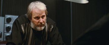Movie still from “Looper” (2012), directed by Rian Johnson – An older man with white hair and a beard; Close Up shot, Over the shoulder angle
