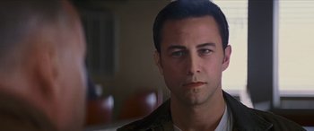 Movie still from “Looper” (2012), directed by Rian Johnson – A person wearing a jacket; Close Up shot, Over the shoulder angle