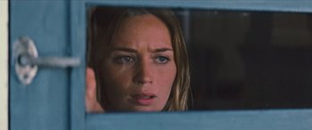 Movie still from “Looper” (2012), directed by Rian Johnson – A person looking through a window; Close Up shot, Over the shoulder angle