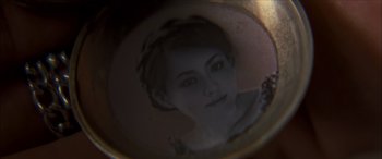 Movie still from “Looper” (2012), directed by Rian Johnson – A reflection of a young woman in a mirror; Extreme Close Up shot, High angle