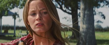 Movie still from “Looper” (2012), directed by Rian Johnson – A person with long brown hair; Close Up shot, Low angle