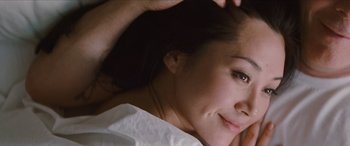 Movie still from “Looper” (2012), directed by Rian Johnson – A person laying on a bed; Close Up shot, Overhead angle