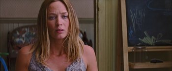 Movie still from “Looper” (2012), directed by Rian Johnson – A person with long blonde hair; Close Up shot, Over the shoulder angle