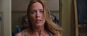 Movie still from “Looper” (2012), directed by Rian Johnson – A person with long blonde hair; Close Up shot, Low angle