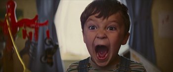 Movie still from “Looper” (2012), directed by Rian Johnson – A little boy with his mouth wide open; Close Up shot, Low angle