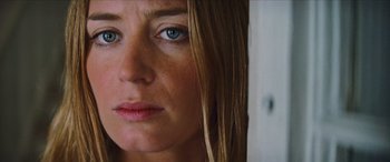 Movie still from “Looper” (2012), directed by Rian Johnson – A woman's face with blue eyes; Close Up shot, Low angle