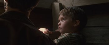 Movie still from “Looper” (2012), directed by Rian Johnson – A young boy looking up at the sky; Close Up shot, Over the shoulder angle