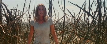 Movie still from “Looper” (2012), directed by Rian Johnson – A woman standing in the middle of a field; Medium shot, Low angle