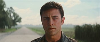 Movie still from “Looper” (2012), directed by Rian Johnson – A person wearing a leather jacket; Close Up shot, Low angle