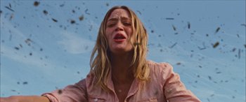 Movie still from “Looper” (2012), directed by Rian Johnson – A woman with long blonde hair and a pink shirt; Close Up shot, Low angle