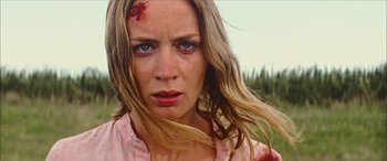 Movie still from “Looper” (2012), directed by Rian Johnson – A person with blood all over her face; Close Up shot, Low angle