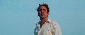 Movie still from “Lord of War” (2005), directed by Andrew Niccol – A person wearing a white shirt; Close Up shot, Low angle