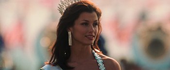 Movie still from “Lord of War” (2005), directed by Andrew Niccol – A beautiful woman with long brown hair wearing a tiara; Close Up shot, Low angle