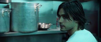 Movie still from “Lord of War” (2005), directed by Andrew Niccol – A person in a kitchen; Close Up shot, Over the shoulder angle