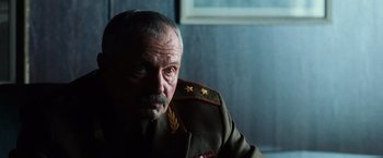 Movie still from “Lord of War” (2005), directed by Andrew Niccol – An older man wearing a military uniform; Close Up shot, Low angle