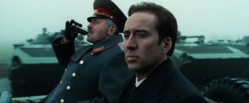 Movie still from “Lord of War” (2005), directed by Andrew Niccol – A man in a military uniform and a man in a uniform; Close Up shot, Low angle