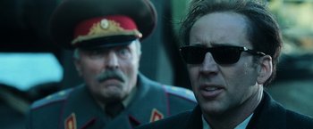 Movie still from “Lord of War” (2005), directed by Andrew Niccol – A man in sunglasses and a military uniform; Close Up shot, Over the shoulder angle