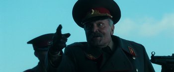 Movie still from “Lord of War” (2005), directed by Andrew Niccol – A person wearing a military uniform; Close Up shot, Low angle