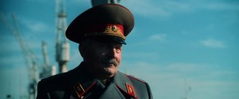 Movie still from “Lord of War” (2005), directed by Andrew Niccol – A person wearing a military uniform; Close Up shot, Low angle