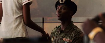Movie still from “Lord of War” (2005), directed by Andrew Niccol – A man in a military uniform is shaking hands with another man; Close Up shot, Low angle