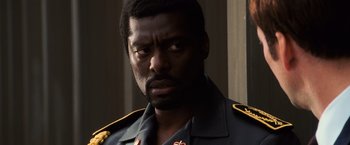 Movie still from “Lord of War” (2005), directed by Andrew Niccol – A person wearing a uniform; Close Up shot, Low angle