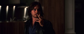 Movie still from “Lord of War” (2005), directed by Andrew Niccol – A person smoking a cigarette; Close Up shot, Over the shoulder angle