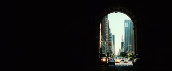 Movie still from “Lord of War” (2005), directed by Andrew Niccol – A view of a city from under an archway; Extreme Wide shot, Low angle