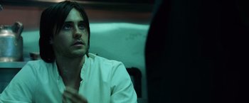 Movie still from “Lord of War” (2005), directed by Andrew Niccol – A man sitting in front of another man in a dark room; Close Up shot, Over the shoulder angle