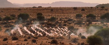 Movie still from “Lord of War” (2005), directed by Andrew Niccol – A field of tents in the middle of the desert; Extreme Wide shot, High angle