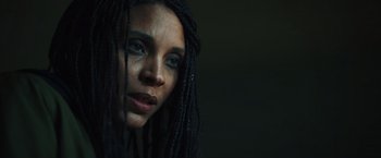 Movie still from “Lost Bullet 2: Back for More” (2022), directed by Guillaume Pierret – A person with dreadlocks; Close Up shot, Low angle