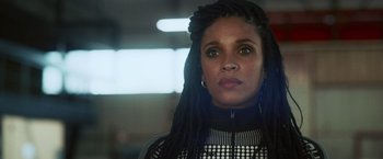 Movie still from “Lost Bullet 2: Back for More” (2022), directed by Guillaume Pierret – A person with dreadlocks; Close Up shot, Low angle