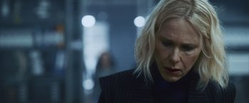 Movie still from “Lost Bullet 2: Back for More” (2022), directed by Guillaume Pierret – A person with blonde hair; Close Up shot, Over the shoulder angle