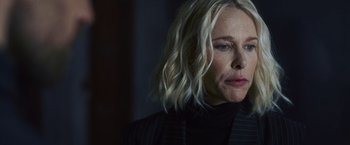 Movie still from “Lost Bullet 2: Back for More” (2022), directed by Guillaume Pierret – A person with blonde hair; Close Up shot, Over the shoulder angle