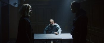 A man sitting at a table with two other men