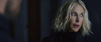 Movie still from “Lost Bullet 2: Back for More” (2022), directed by Guillaume Pierret – A woman with blonde wavy hair wearing a black jacket; Close Up shot, Over the shoulder angle