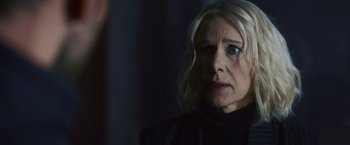 Movie still from “Lost Bullet 2: Back for More” (2022), directed by Guillaume Pierret – A person wearing a black shirt; Close Up shot, Over the shoulder angle