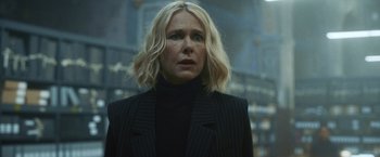 Movie still from “Lost Bullet 2: Back for More” (2022), directed by Guillaume Pierret – A woman with blonde hair wearing a black jacket; Close Up shot, Low angle