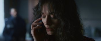 Movie still from “Lost Bullet 2: Back for More” (2022), directed by Guillaume Pierret – A person talking on a cell phone; Close Up shot, High angle