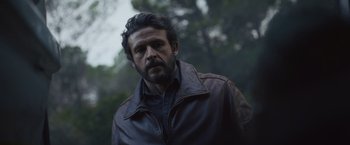 Movie still from “Lost Bullet 2: Back for More” (2022), directed by Guillaume Pierret – A person wearing a leather jacket; Close Up shot, Over the shoulder angle