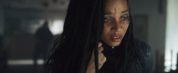 Movie still from “Lost Bullet 2: Back for More” (2022), directed by Guillaume Pierret – A person with dreads; Close Up shot, Low angle