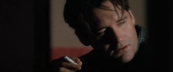 Movie still from “Lost Highway” (1997), directed by David Lynch – A person holding a nintendo wii game controller; Close Up shot, Low angle