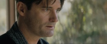 Movie still from “Lost Highway” (1997), directed by David Lynch – A man's face with trees in the background; Close Up shot, Over the shoulder angle