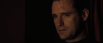 Movie still from “Lost Highway” (1997), directed by David Lynch – A person's face in the dark; Close Up shot, Low angle