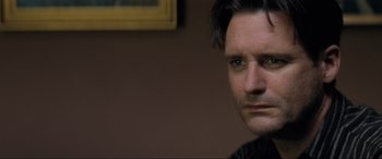 Movie still from “Lost Highway” (1997), directed by David Lynch – A person wearing a black jacket; Close Up shot, Over the shoulder angle