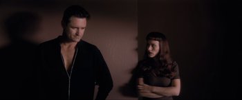Movie still from “Lost Highway” (1997), directed by David Lynch – A man and a woman standing next to each other; Medium shot, Low angle
